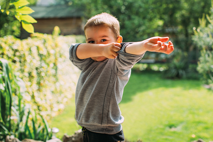 Child rolling up sleeve mobile view